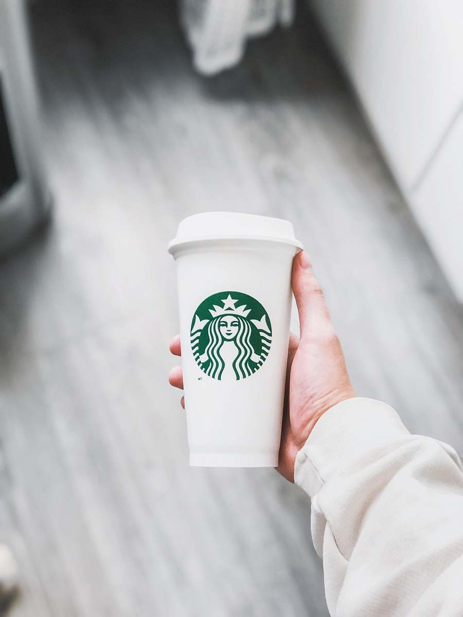 coffee cup person holding white Starbucks disposable cup cup